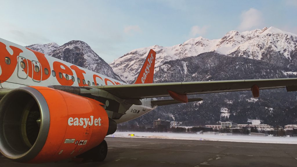 An Easy Jet with snow-capped mountains in the background