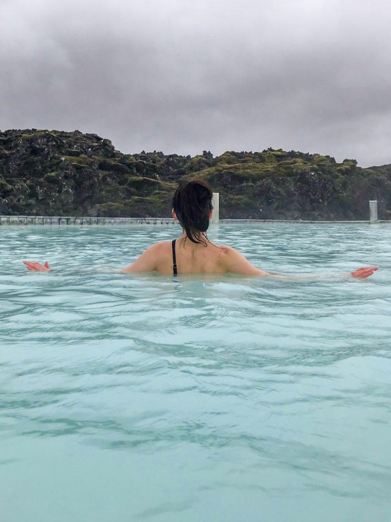 A girl in swimsuit visiting Blue Lagoon Iceland looking away