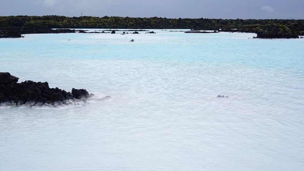 A lagoon with blueish water surrounded by rocks