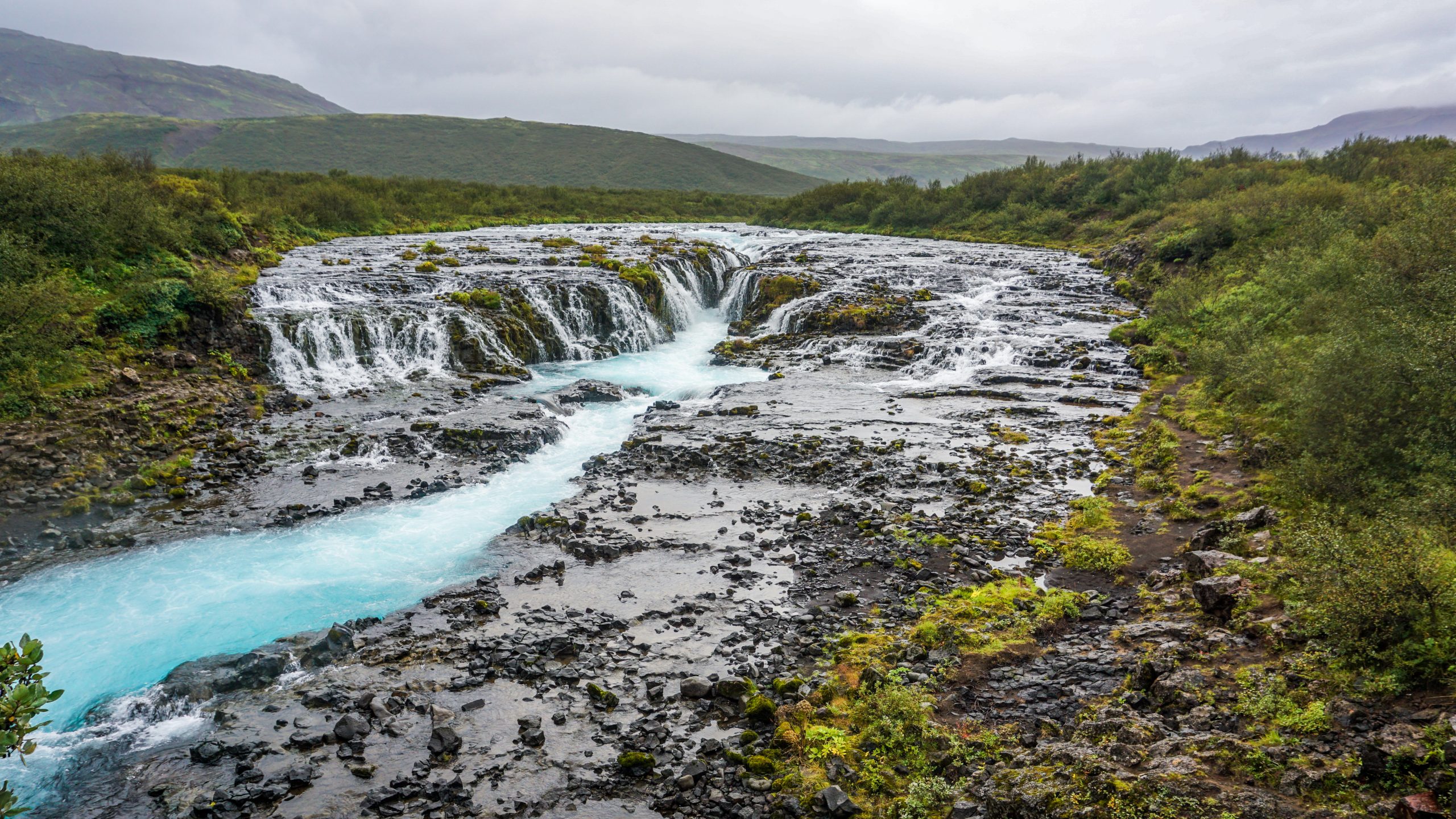 A waterfall with light blue colour and many branches in Iceland's Golden Circle region
