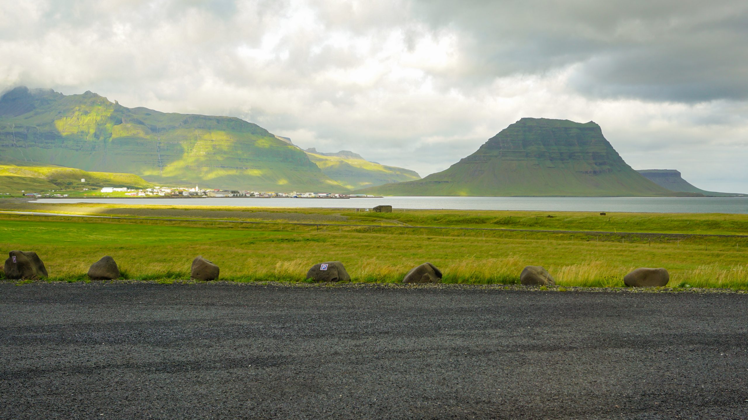 View of a mountain and a lake behind a carpark in Iceland
